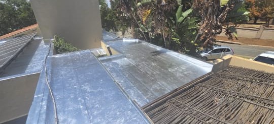 Flat roof finished with torch-on and a silver aluminium UV coat